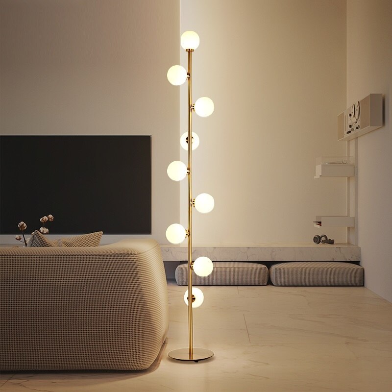 Lights of Scandinavia - Nucleic - Modern LED standing lamp with frosted glass ball fixtures. Nickel gold plated steel body. Suitable for bedrooms, halls or next to a lonely wall. 9 light sources with a coverage of approximately 6-12 square meters, using the included LED Bulbs. Base diameter: 25cm Glass ball diameter: 10cm Specifications Light Source 9x LED Bulbs Base Type G4 Power Consumption 16-20W Is Bulbs Included Yes Dimmable