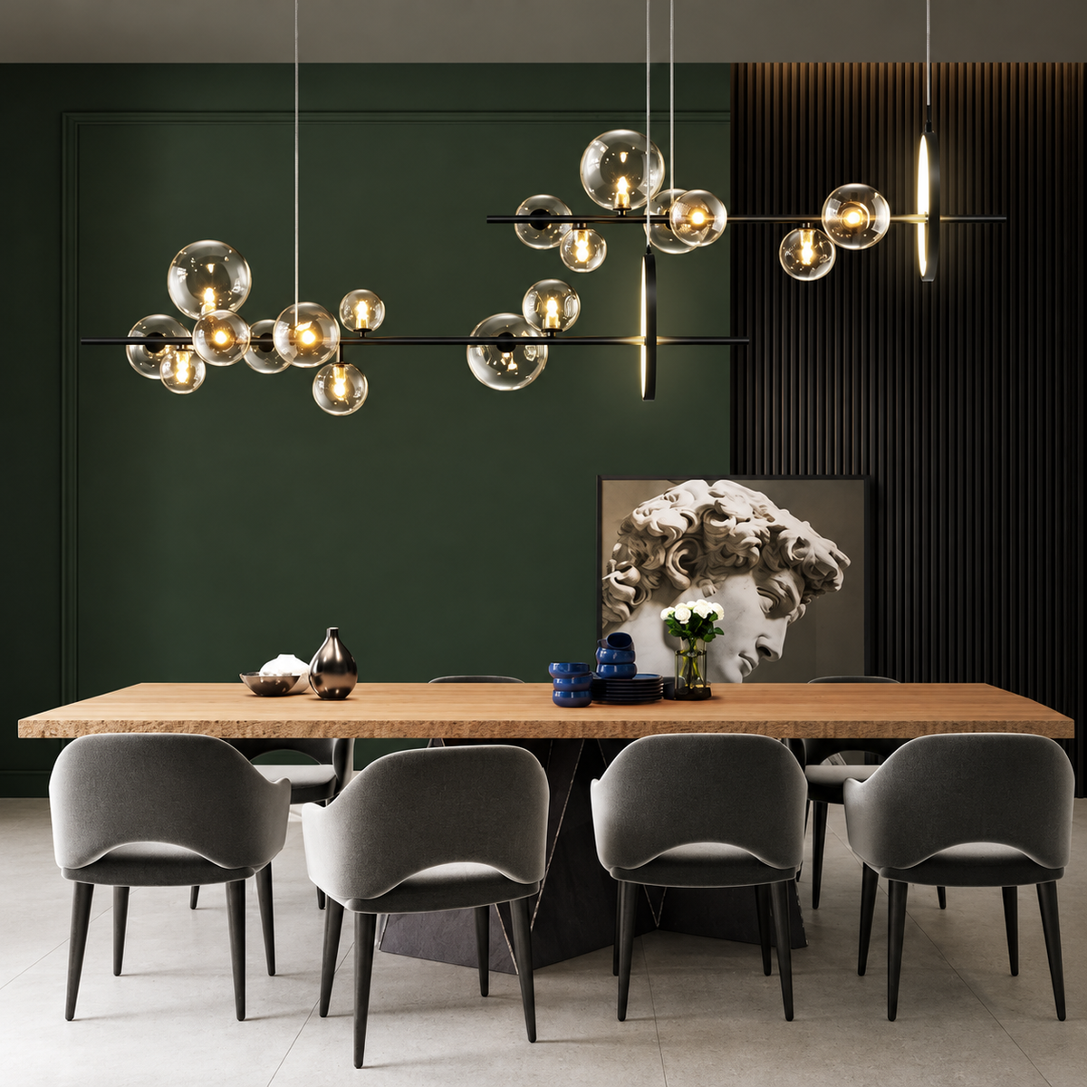 A modern dining room scene with a long wooden table, six gray upholstered chairs, and two large spherical pendant light fixtures hanging above. The wall behind is dark green with black slatted paneling on the right, and a framed classical bust artwork sits above the table.